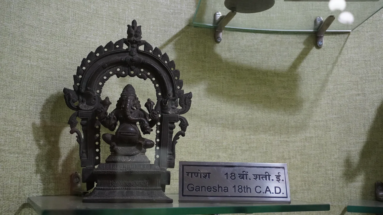18th-century bronze Ganesha in a glass case at the Birla Museum, Bhopal