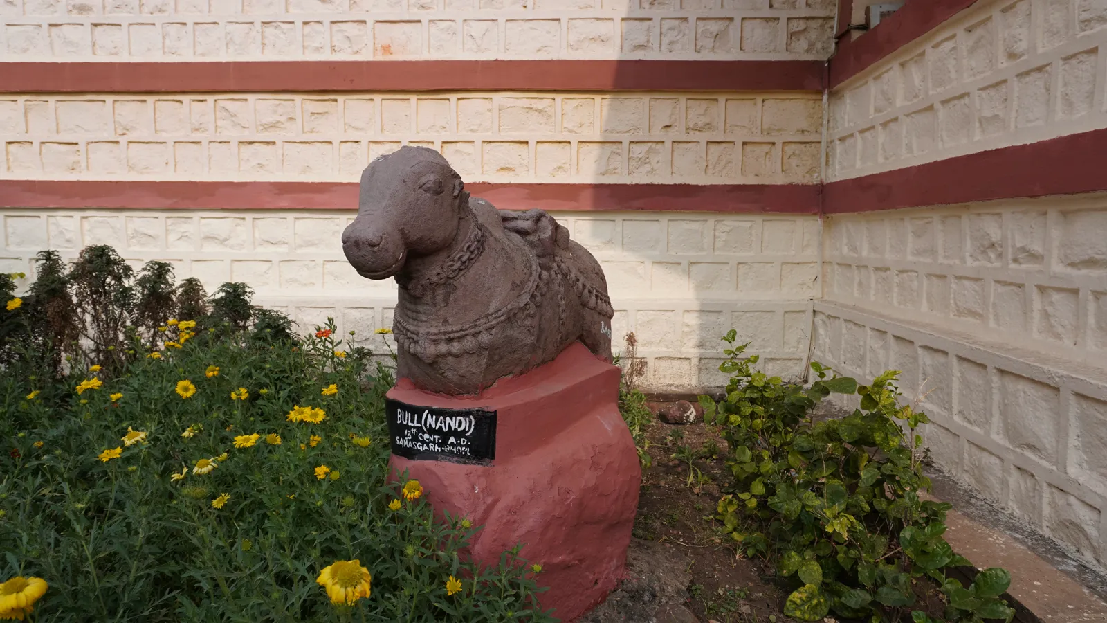 Stone Nandi bull from Samasgarh, 13th century AD, among flowers at the Birla Museum, Bhopal