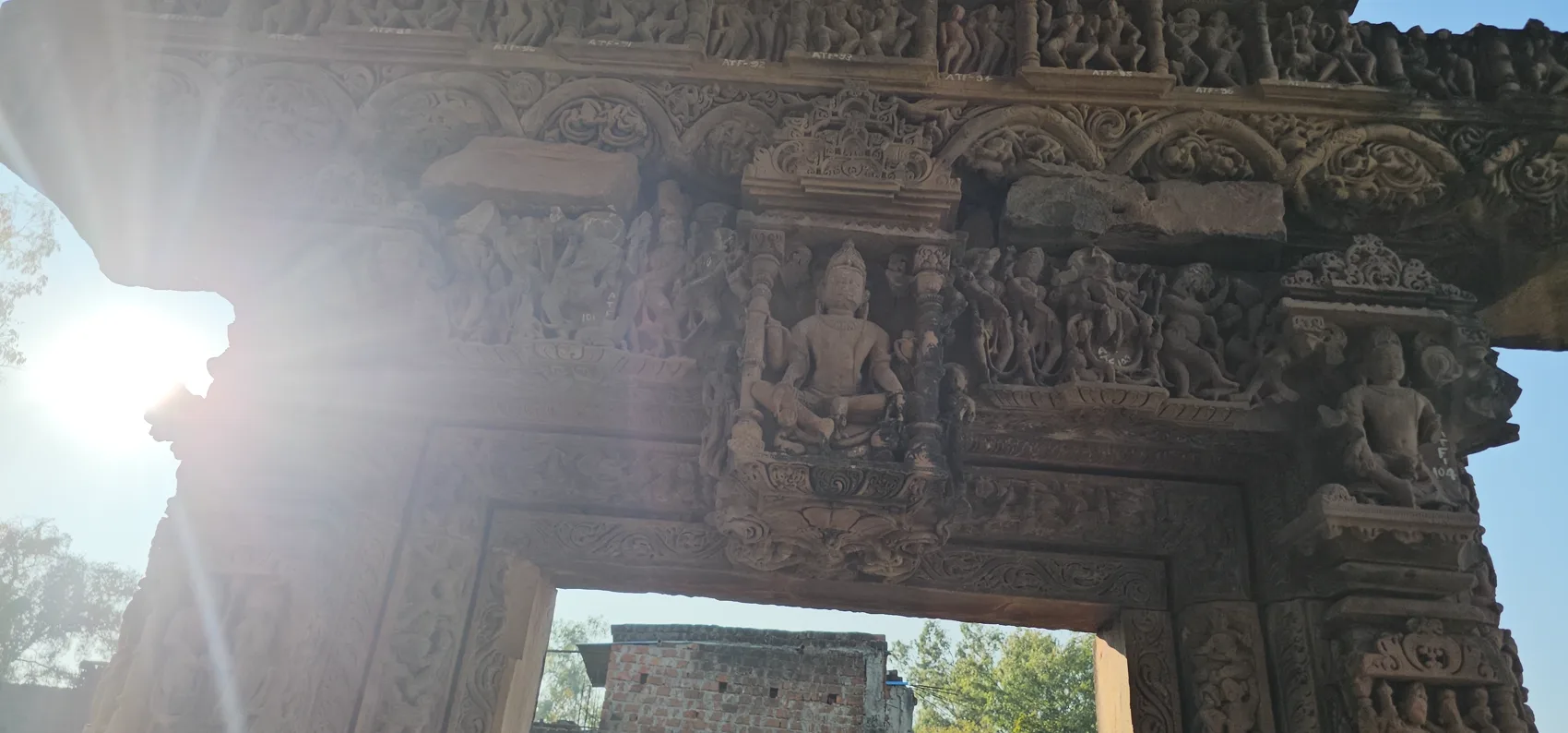 The Athkhamba ruins backlit by the afternoon sun