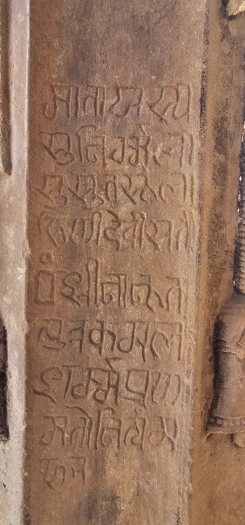 A weathered stone inscription at the Maladevi Temple