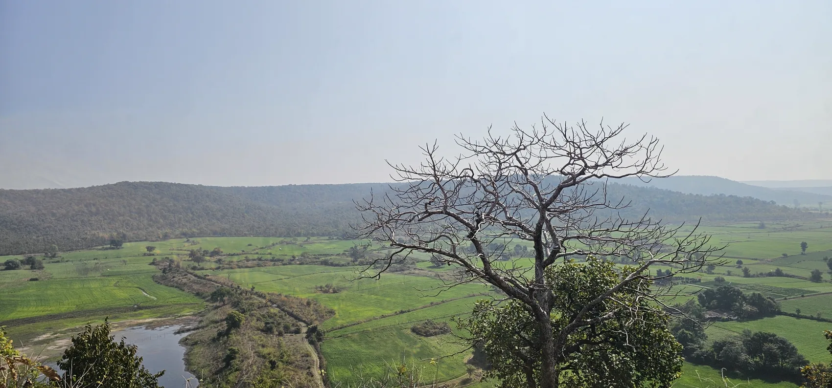 The green valley and farmland seen from the Maladevi temple ridge
