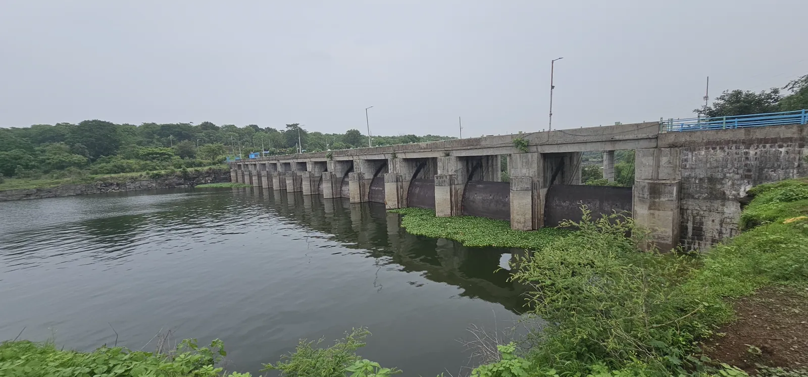 The long line of the Kaliasot dam barrage and its gates across the monsoon water