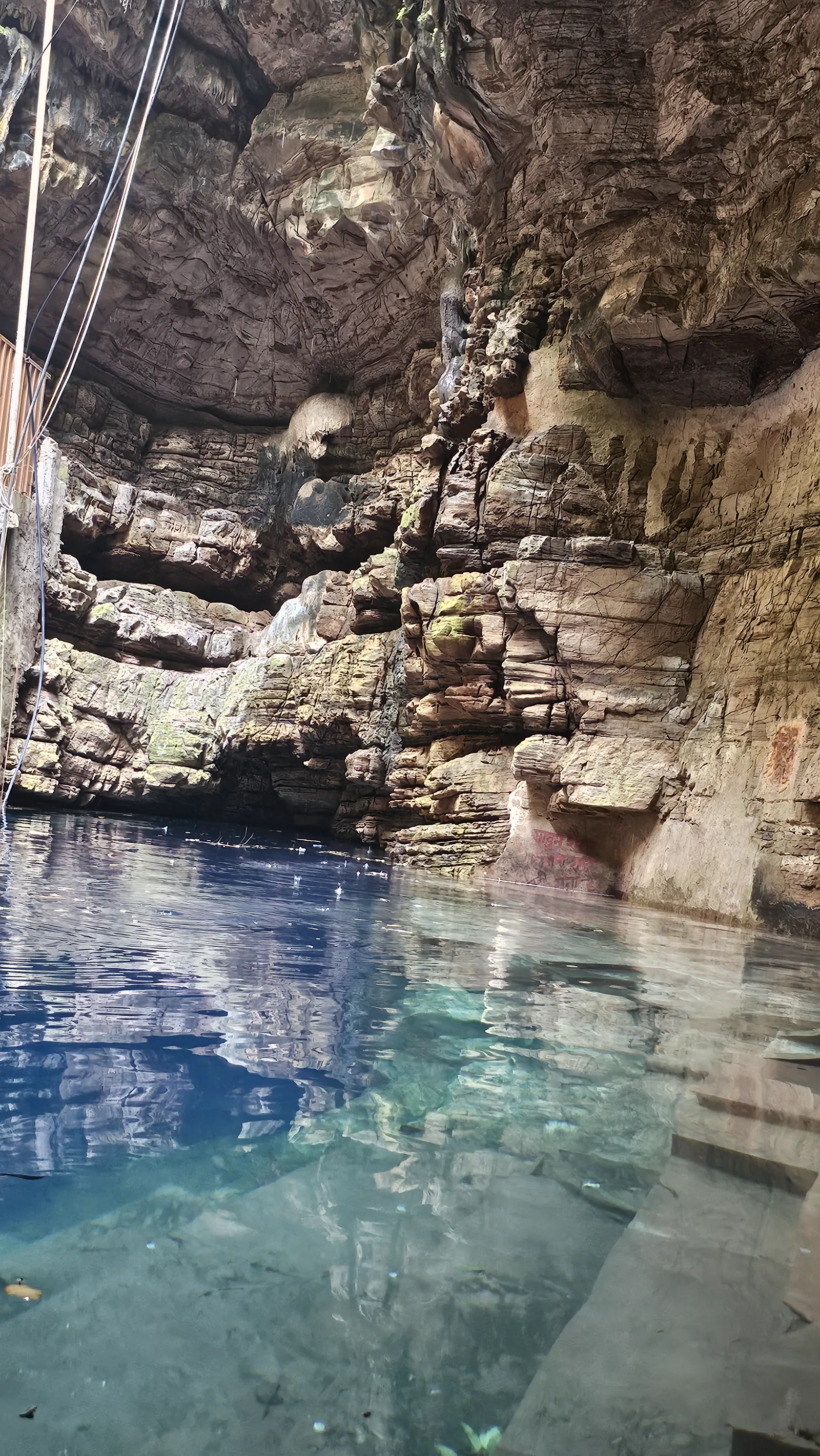 The impossibly blue clear water of Bhimkund with fish suspended in it