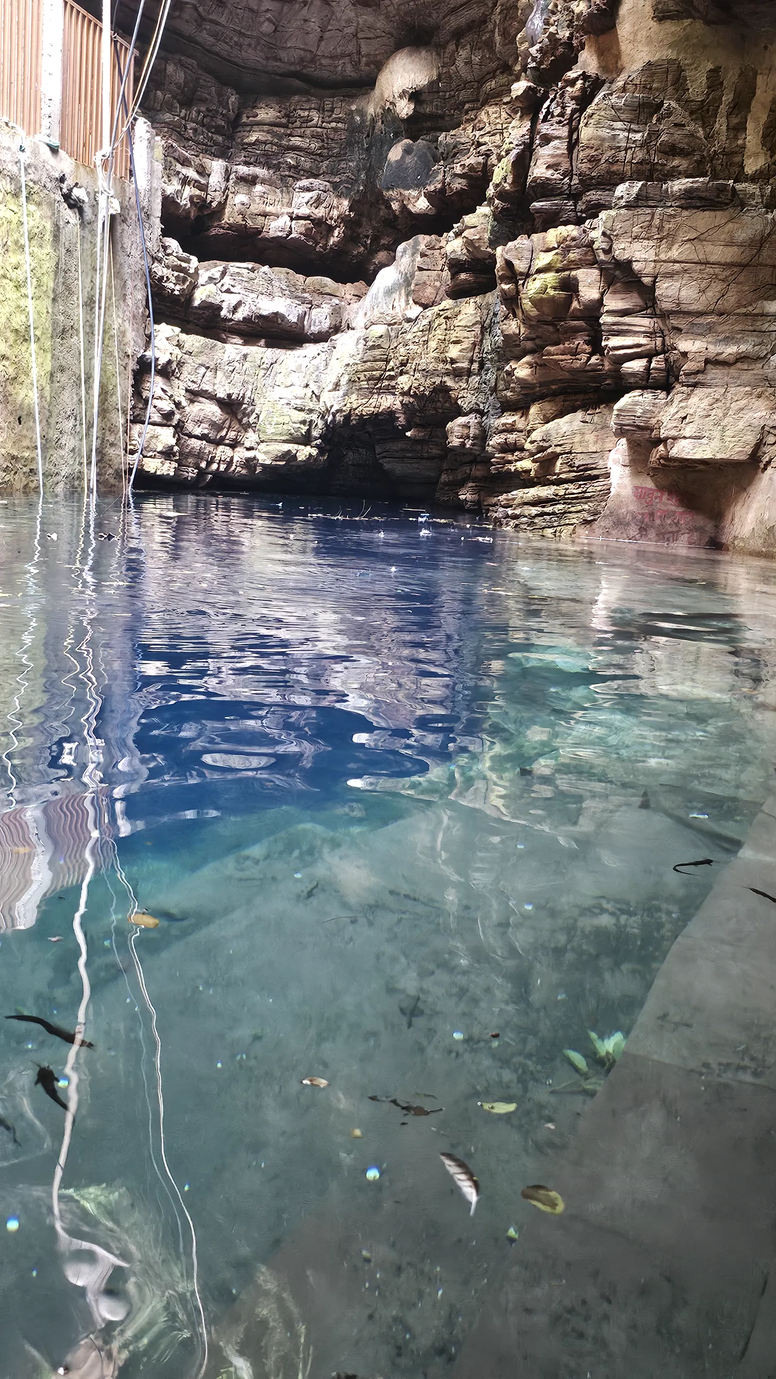 The blue kund of Bhimkund seen inside the mouth of its low cave