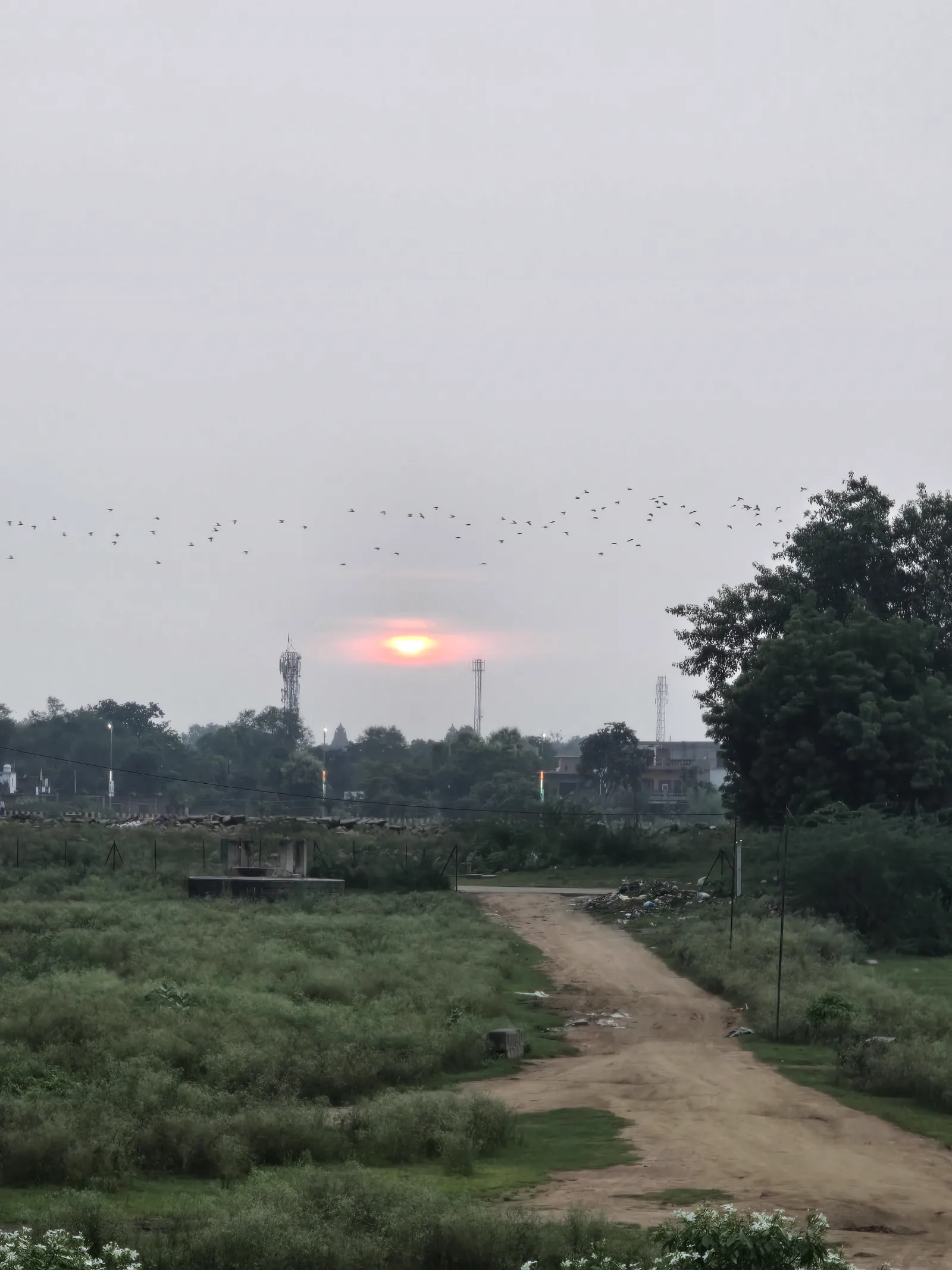 A pink monsoon sunset over the temples of Khajuraho