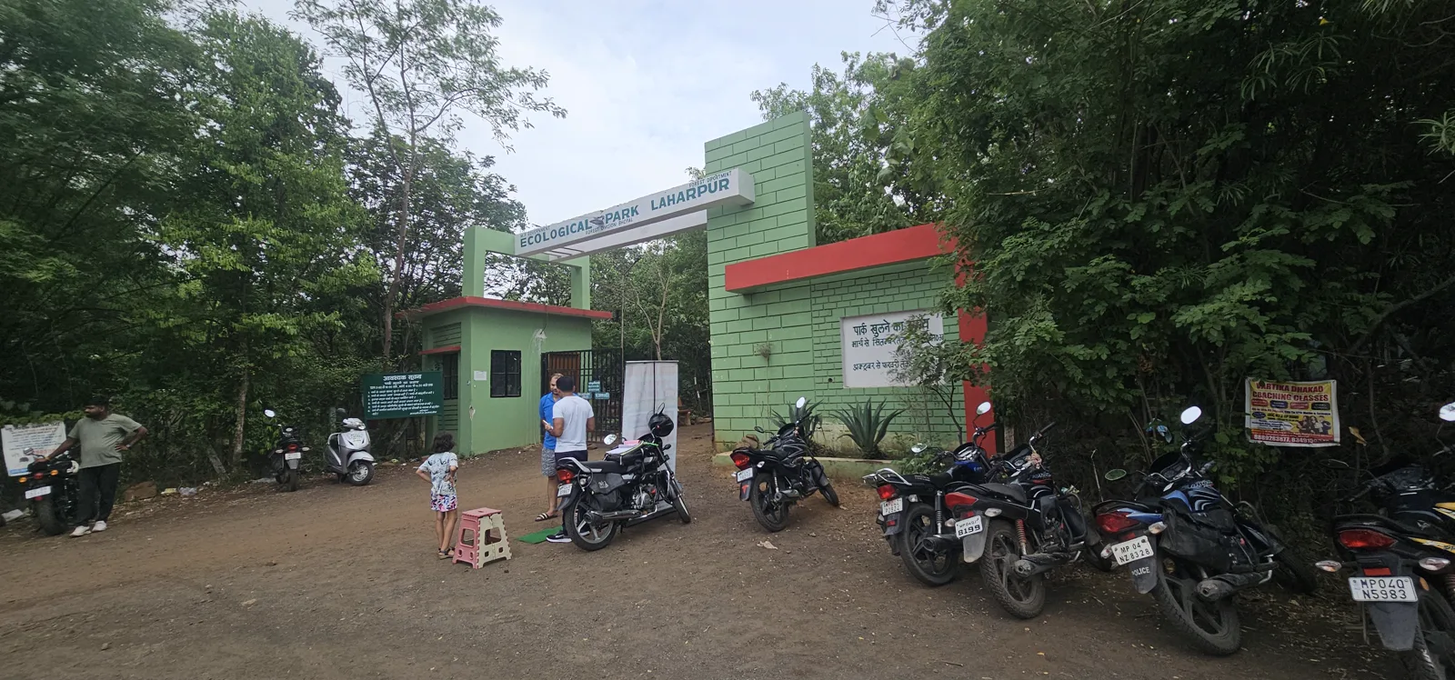 Motorbikes parked at the Laharpur park gate as early-morning visitors arrive