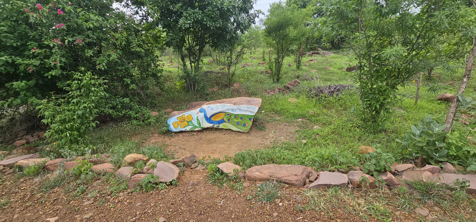 A painted rock marking a path junction inside Laharpur Ecological Park