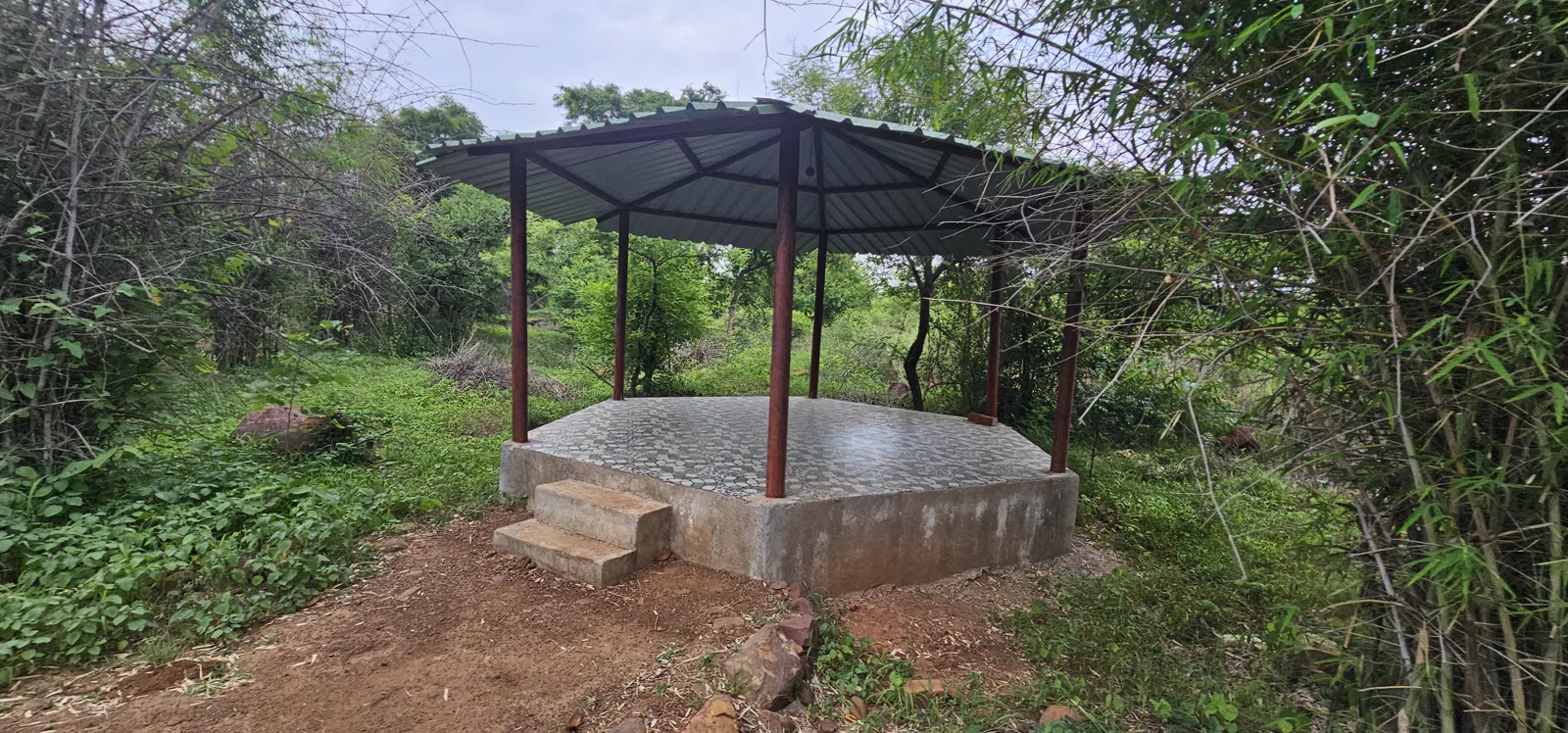 A canopy-roofed sitting hut or machan on a raised platform among the trees at Laharpur