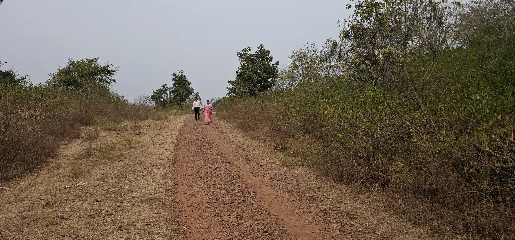The red-dirt path climbing toward the fort