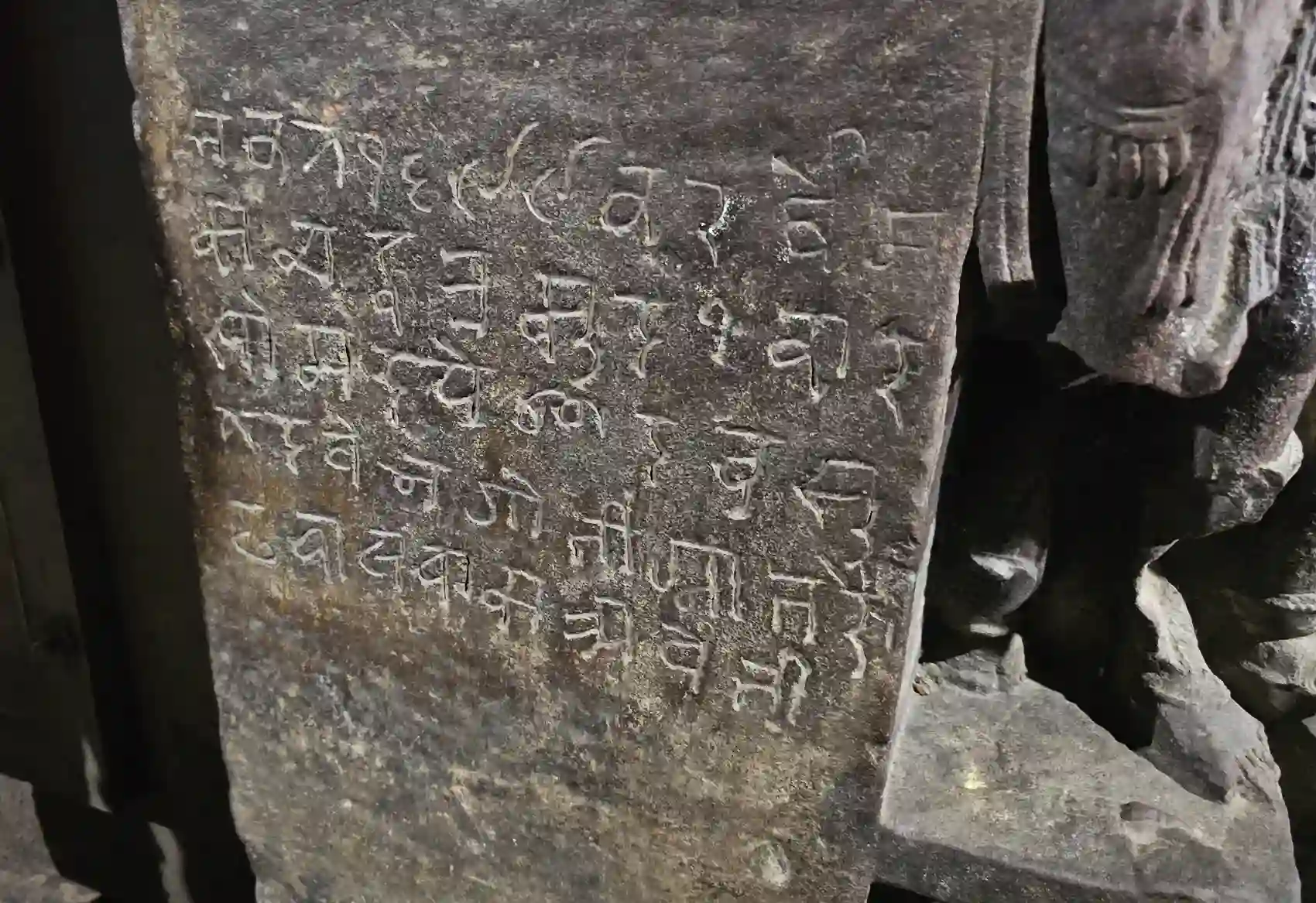 An old carved stone inscription slab inside the Neelkantheshwar temple