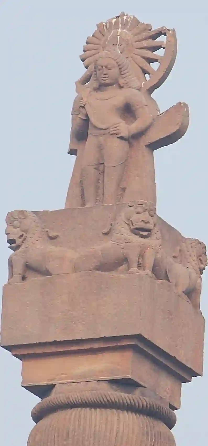 A tall ancient stone pillar standing in the field at Eran, Sagar district