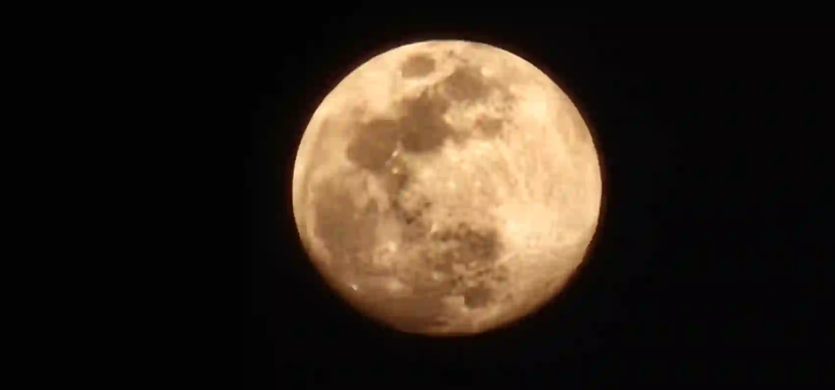 A large full moon over the countryside near Gyaraspur at dusk