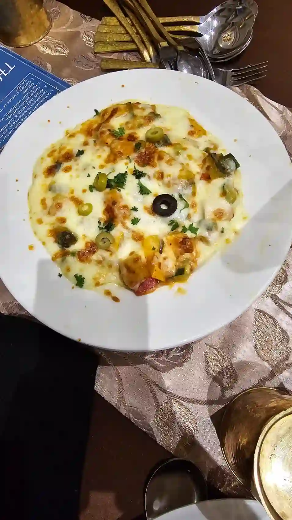 A hot cheese-baked dish at dinner in the Utopia Resort near Sanchi