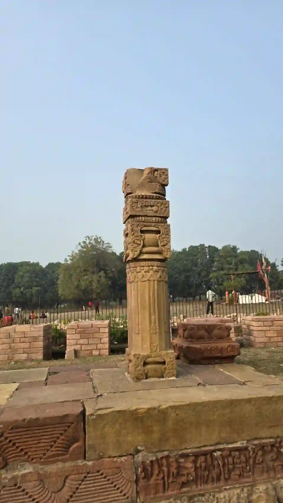 Close view of the carved capital and plinth of the Garuda pillar at Eran