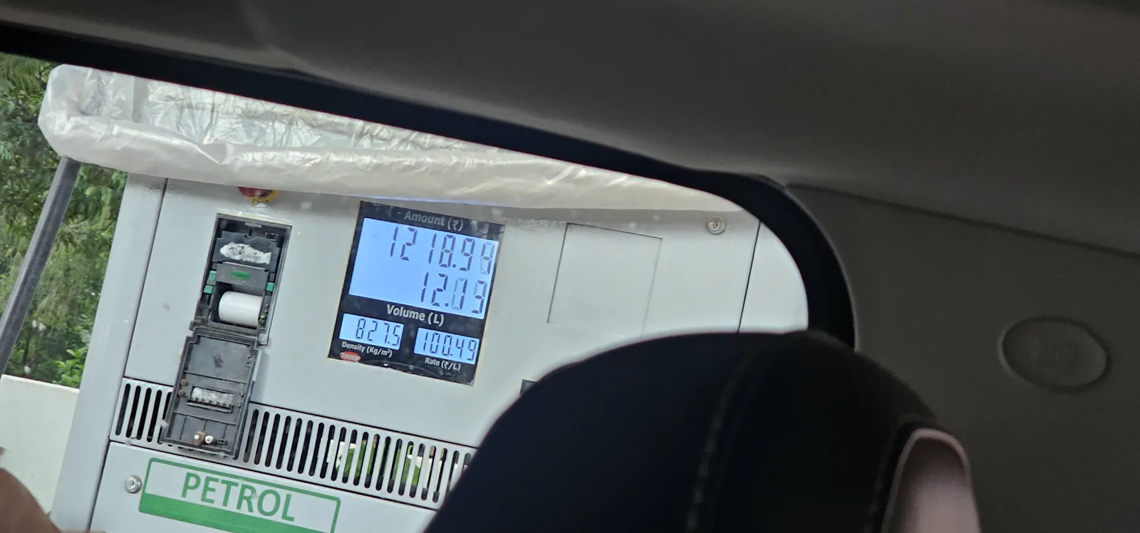 A fuel pump display in Pachmarhi showing the rate at 100.49 rupees per litre