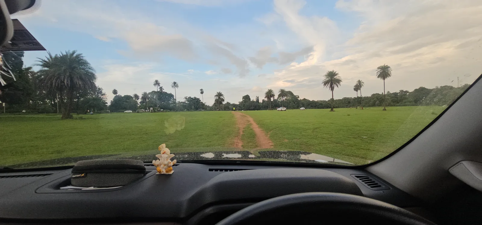 The wide green meadow by the Boat Club ground in Pachmarhi, where horses graze in the evening