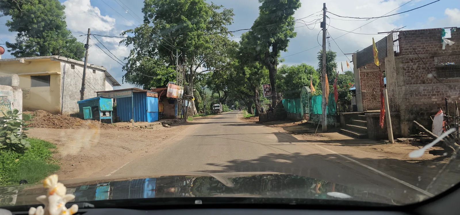 Green village road in the Satpura foothills below Pachmarhi during the rains